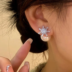 Model showcasing the dangle and style of the 14K Gold-Plated Elegant Zircon Snowflake Pearl Earrings