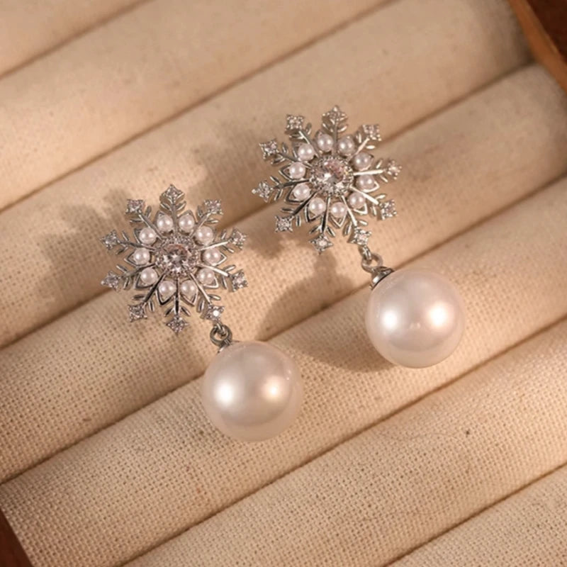 Angled view of the 14K Gold-Plated Elegant Zircon Snowflake Pearl Earrings