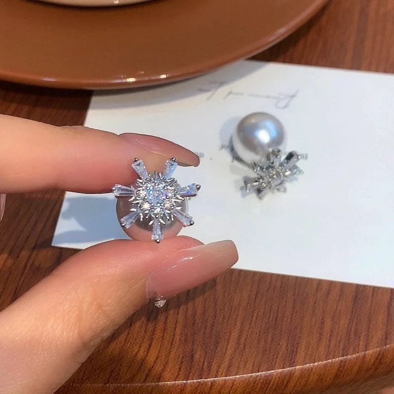 Angled view of the 14K Gold-Plated Elegant Zircon Snowflake Pearl Earrings