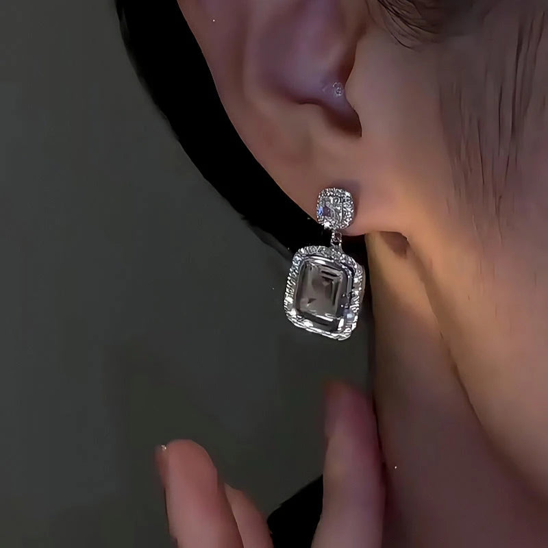 Model showcasing the dangle and style of the 14K Gold-Plated Elegant Zircon Square Diamond Earrings