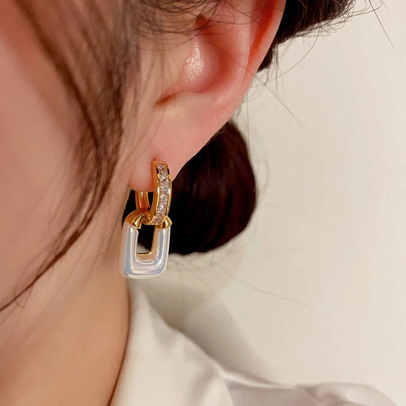 Model showcasing the dangle and style of the 14K Gold-Plated Elegant Zircon Square Earrings