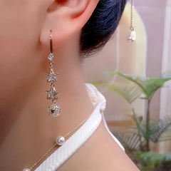 Model showcasing the dangle and style of the 14K Gold-Plated Elegant Zircon Star Ball Ear Hook Earrings