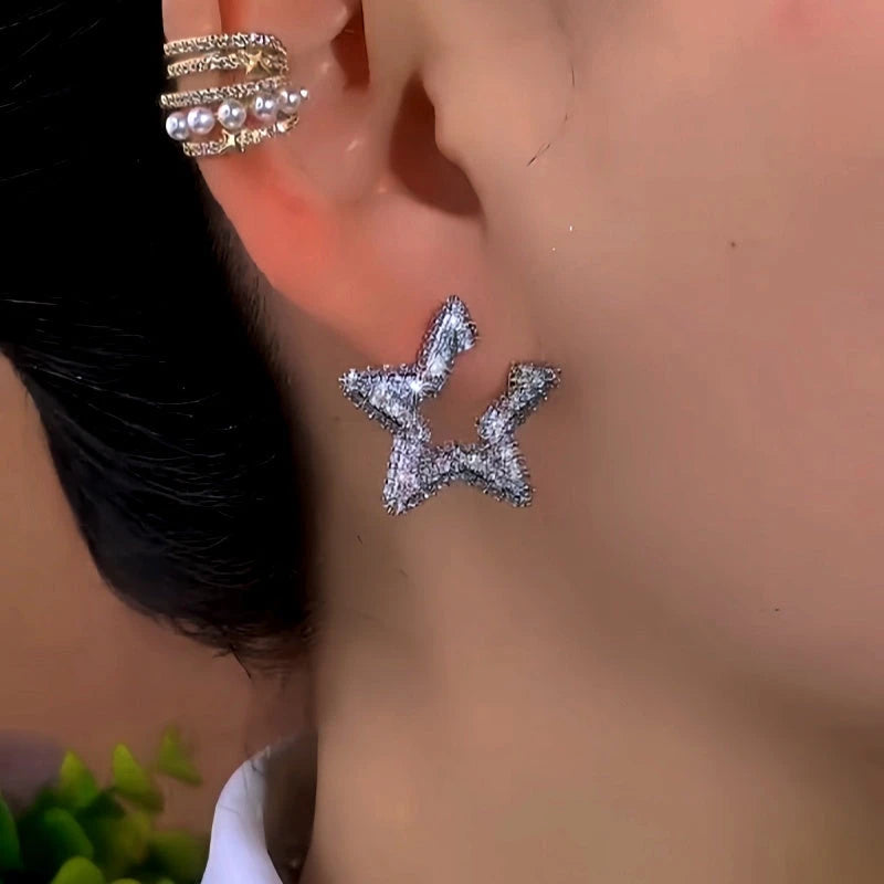 Model showcasing the dangle and style of the 14K Gold-Plated Elegant Zircon Star Earrings