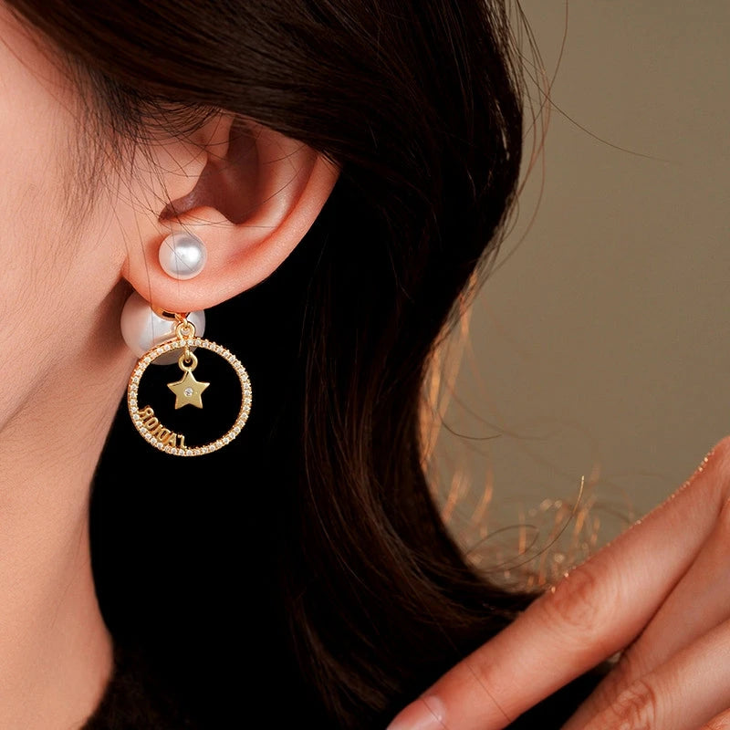 Model showcasing the dangle and style of the 14K Gold-Plated Elegant Zircon Star Pearl Two-Piece Earrings