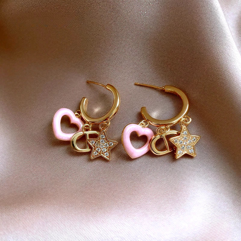 Angled view of the 14K Gold-Plated Elegant Zircon Star Pig Nose Pink Heart Tassel Earrings