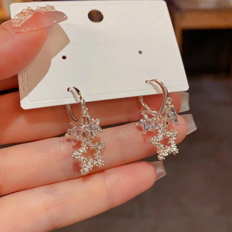 Model showcasing the dangle and style of the 14K Gold-Plated Elegant Zircon Star Tassel Earrings