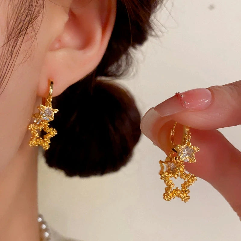 Close-up detail of the sparkling zircons and plating on the Star Tassel Earrings