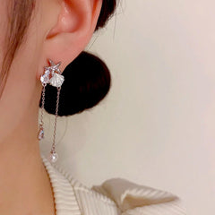 Model showcasing the dangle and style of the 14K Gold-Plated Elegant Zircon Starfish Shell Tassel Earrings