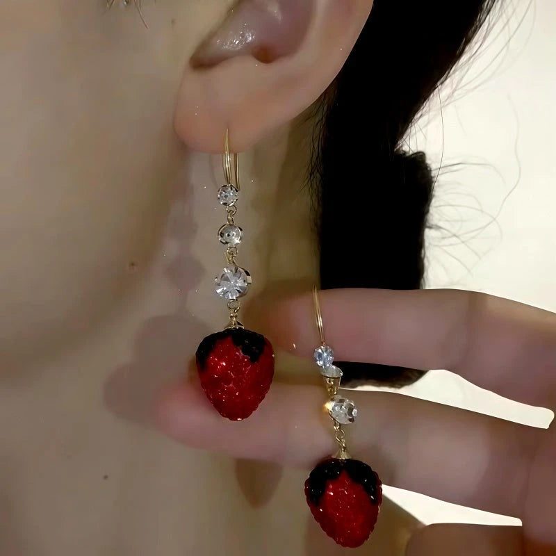 Model showcasing the dangle and style of the 14K Gold-Plated Elegant Zircon Strawberry Ear Hooks
