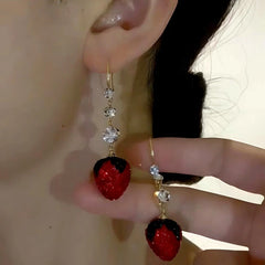 Model showcasing the dangle and style of the 14K Gold-Plated Elegant Zircon Strawberry Ear Hooks