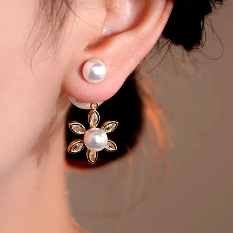 Model showcasing the dangle and style of the 14K Gold-Plated Elegant Zircon Sun Pearl Jacket Earrings