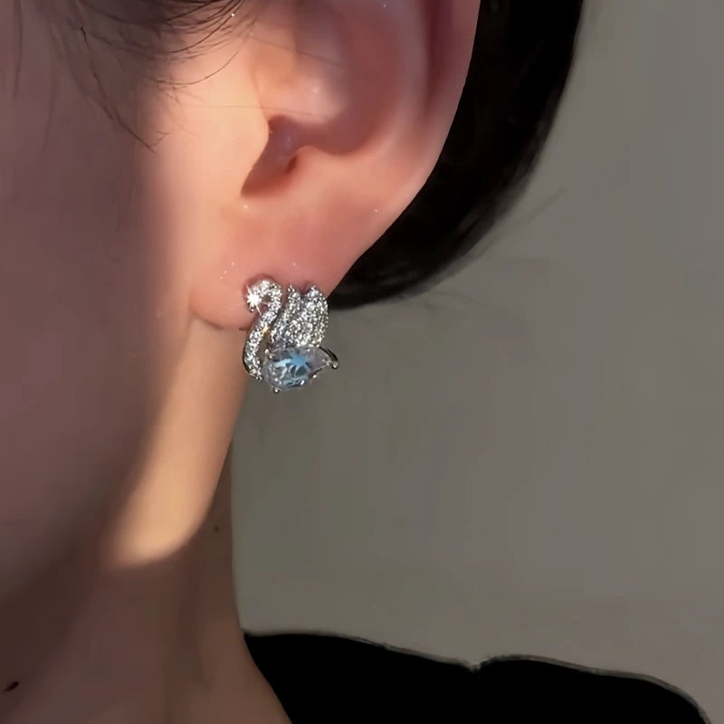 Close-up detail of the sparkling zircons and plating on the Swan Earrings