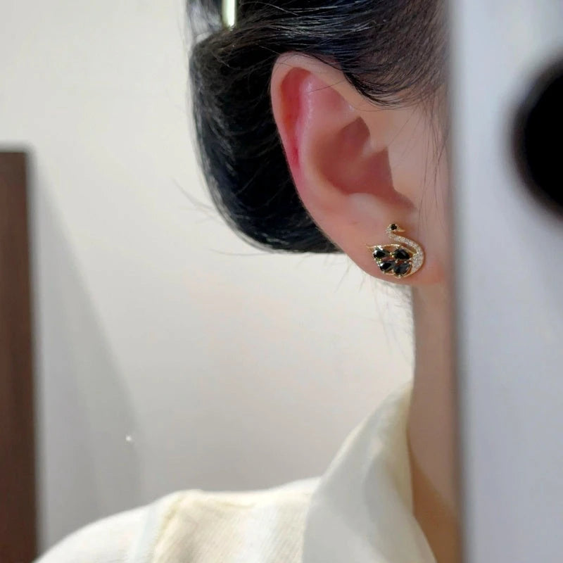 Angled view of the 14K Gold-Plated Elegant Zircon Swan Stud Earrings