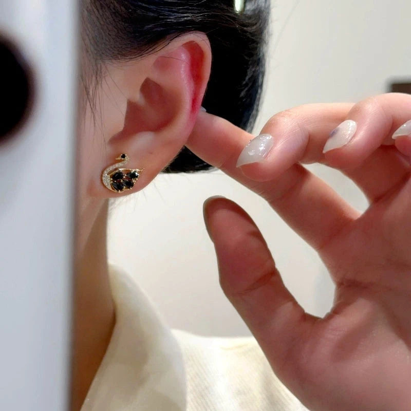 Close-up detail of the sparkling zircons and plating on the Swan Stud Earrings