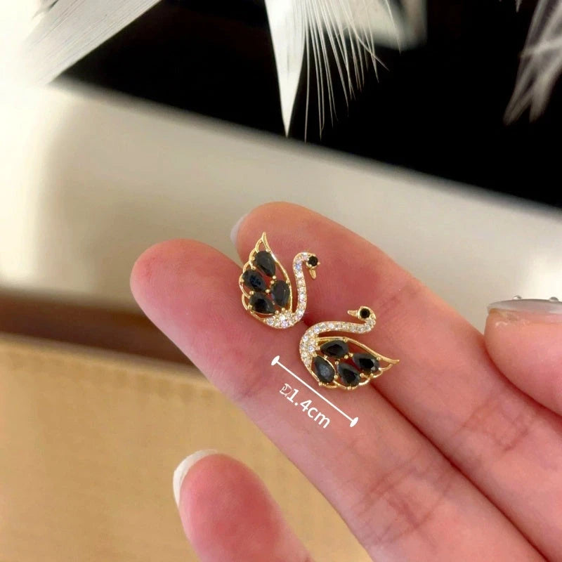 Model showcasing the dangle and style of the 14K Gold-Plated Elegant Zircon Swan Stud Earrings