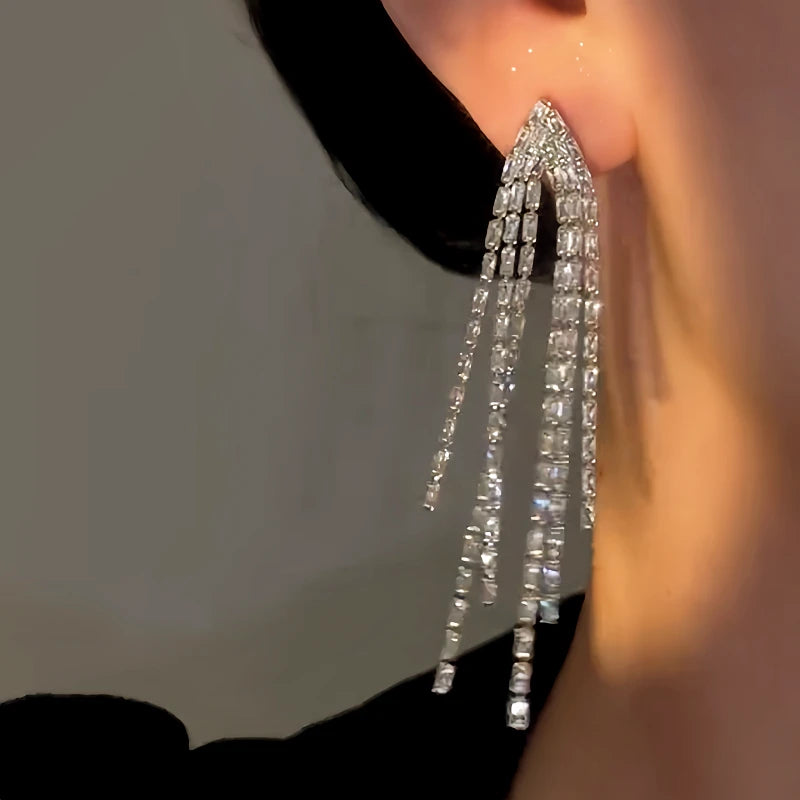 Model showcasing the dangle and style of the 14K Gold-Plated Elegant Zircon Tassel Earrings