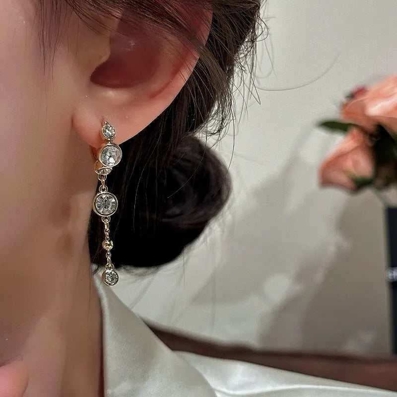 Close-up detail of the sparkling zircons and plating on the Bow Tassel Earrings