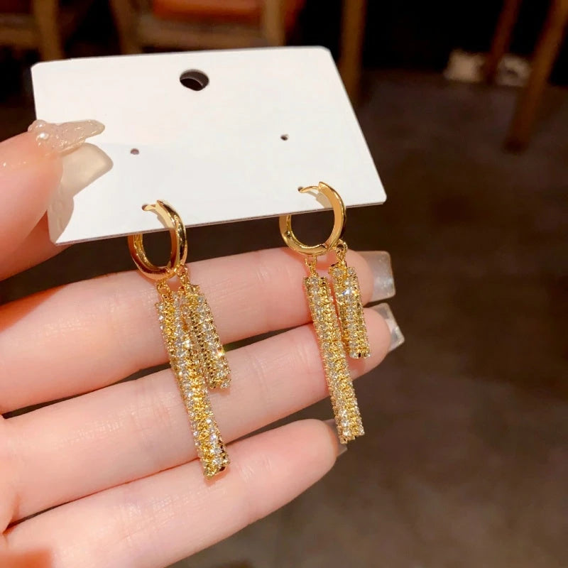 Angled view of the 14K Gold-Plated Elegant Zircon Tassel Earrings