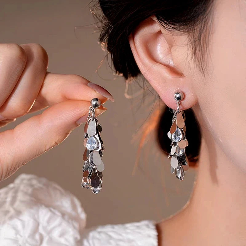 Model showcasing the dangle and style of the 14K Gold-Plated Elegant Zircon Tassel Earrings