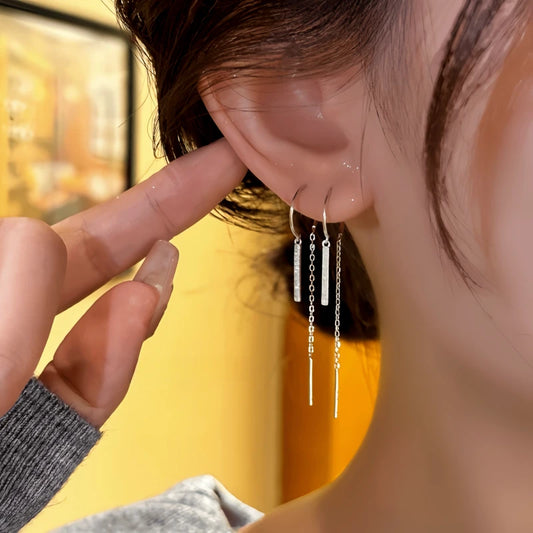 Model showcasing the dangle and style of the 14K Gold-Plated Elegant Zircon Tassel Threader Earrings