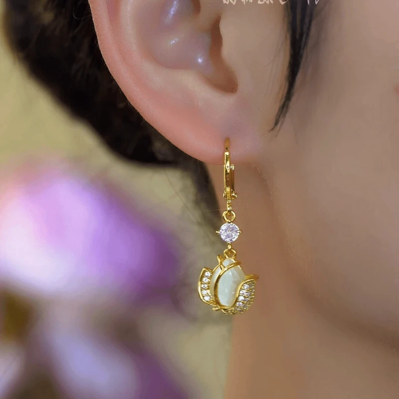 Model showcasing the dangle and style of the 14K Gold-Plated Elegant Zircon Tulip Earrings
