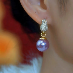 Model showcasing the dangle and style of the 14K Gold-Plated Elegant Zircon Tulip Flower Pearl Earrings