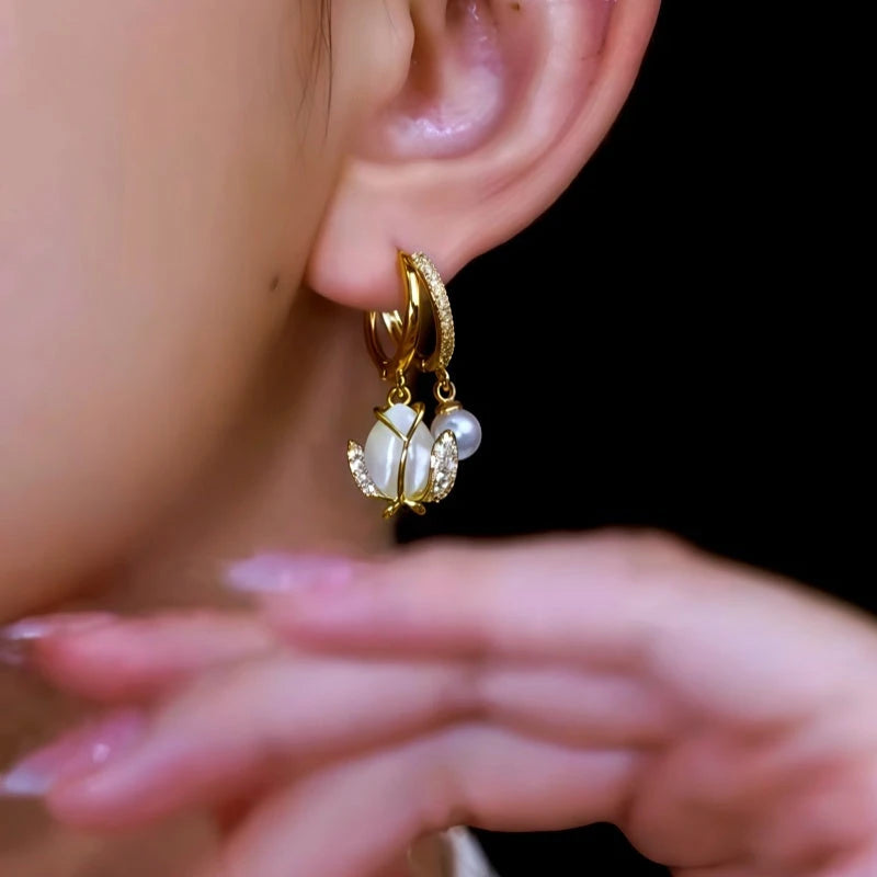 Close-up detail of the sparkling zircons and plating on the Tulip Pearl Earrings