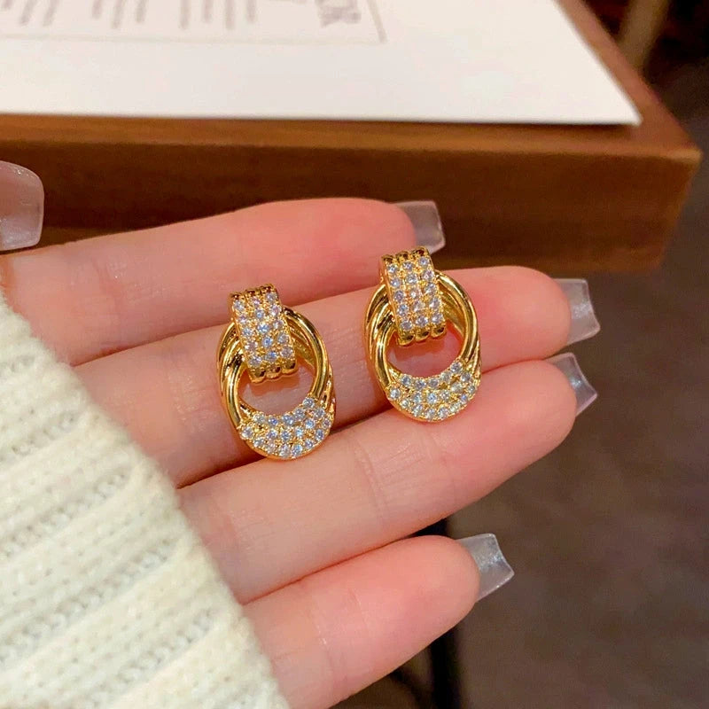 Close-up detail of the sparkling zircons and plating on the Twisted Gold Earrings