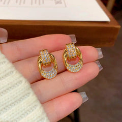 Close-up detail of the sparkling zircons and plating on the Twisted Gold Earrings