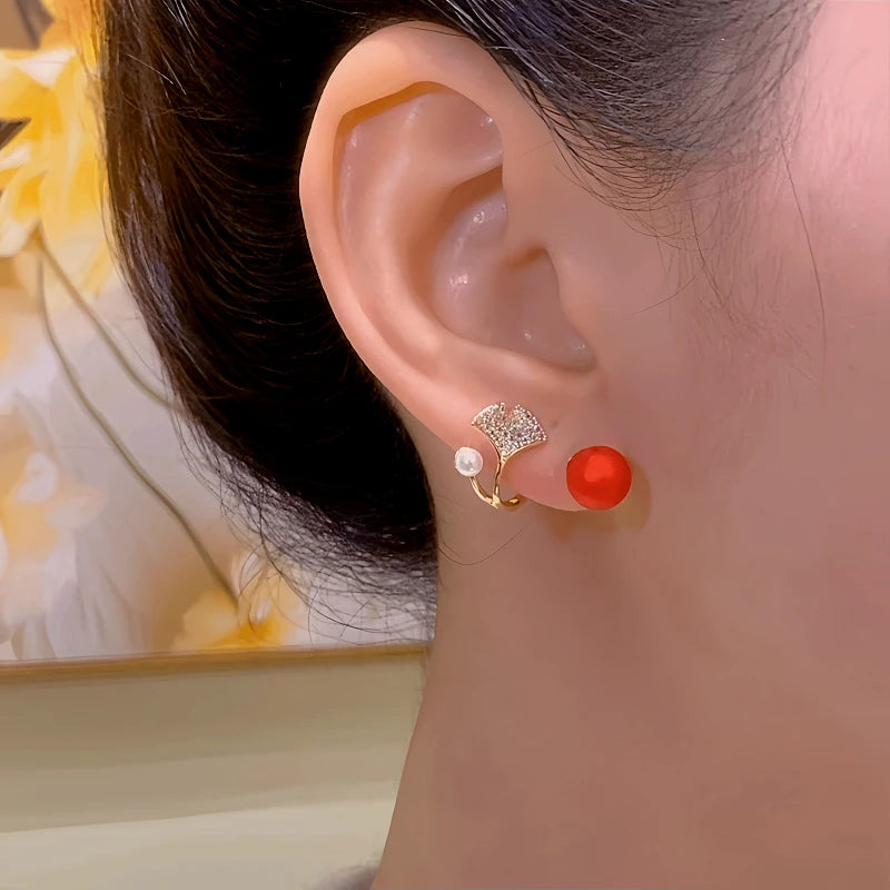 Model showcasing the dangle and style of the 14K Gold-Plated Elegant Zircon Two-Piece Ginkgo Leaf Earrings