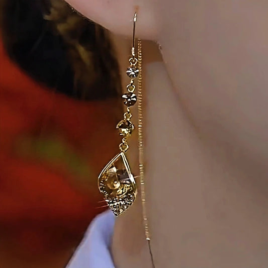 Model showcasing the dangle and style of the 14K Gold-Plated Elegant Zircon Water Drop Earrings