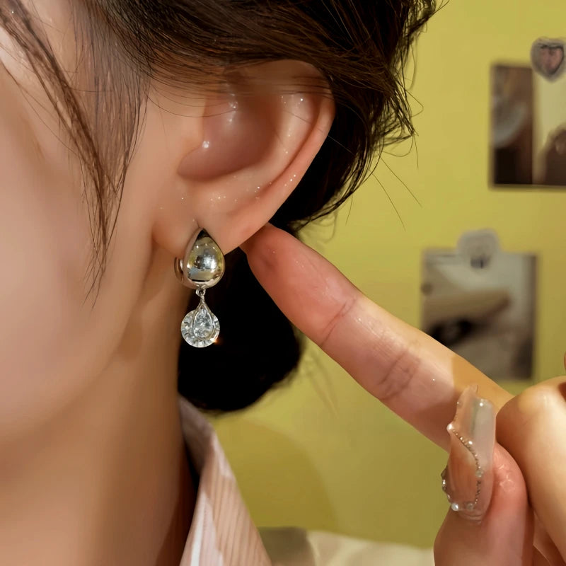 Model showcasing the dangle and style of the 14K Gold-Plated Elegant Zircon Water Drop Earrings