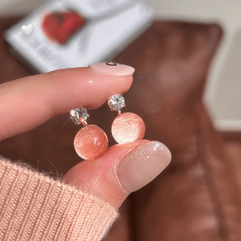 Model showcasing the dangle and style of the 14K Gold-Plated Elegant Zircon Water Drop Earrings