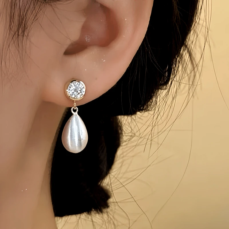 Close-up detail of the sparkling zircons and plating on the Open Teardrop Earrings