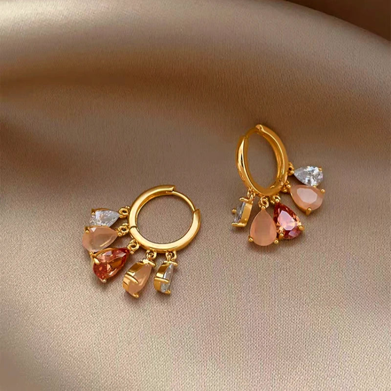 Model showcasing the dangle and style of the 14K Gold-Plated Elegant Zircon Water Drop Earrings