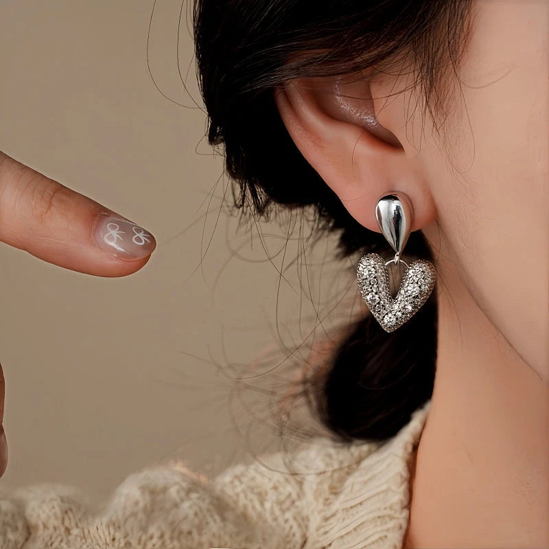 Close-up detail of the sparkling zircons and plating on the Heart Drop Earrings