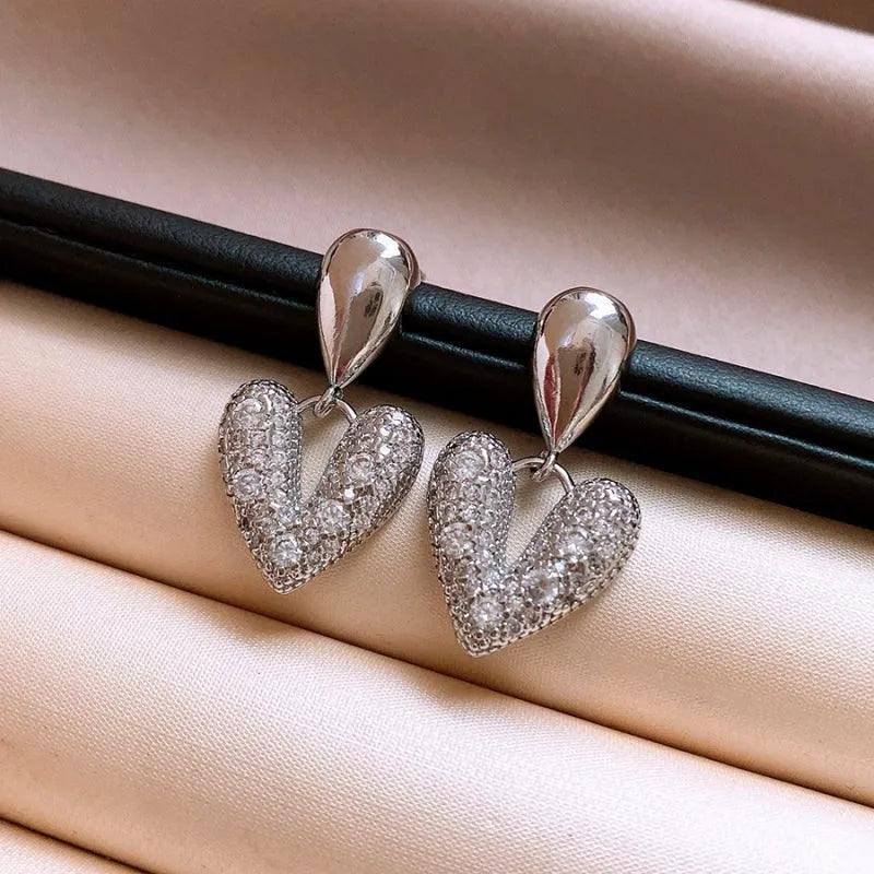 Model showcasing the dangle and style of the 14K Gold-Plated Elegant Zircon Water Drop Heart Earrings