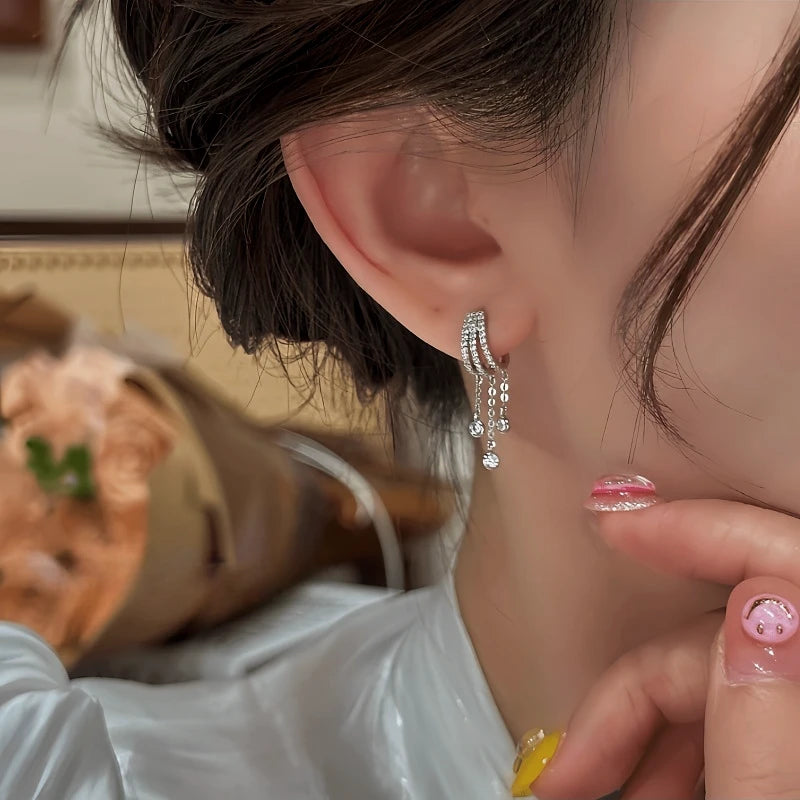 Close-up detail of the sparkling zircons and plating on the Teardrop Tassel Earrings