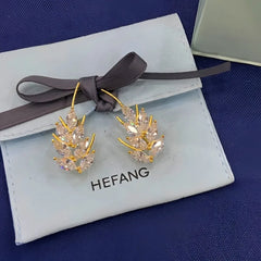 Model showcasing the dangle and style of the 14K Gold-Plated Elegant Zircon Wheat Crawler Earrings