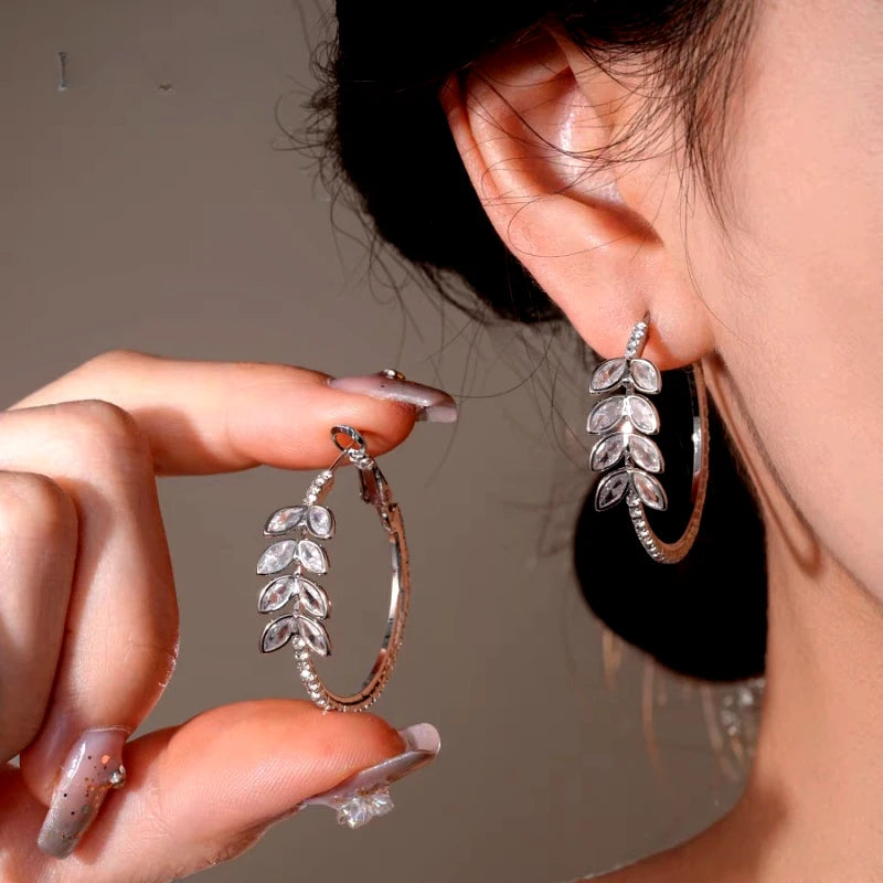 Model showcasing the dangle and style of the 14K Gold-Plated Elegant Zircon Wheat Hoop Earrings