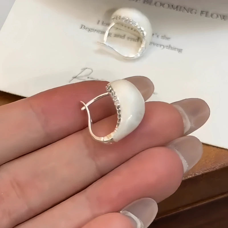 Close-up detail of the sparkling zircons and plating on the White Glaze Earrings