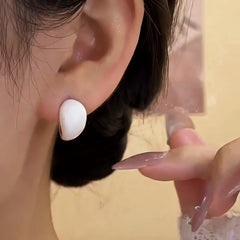 Model showcasing the dangle and style of the 14K Gold-Plated Elegant Zircon White Glaze Earrings