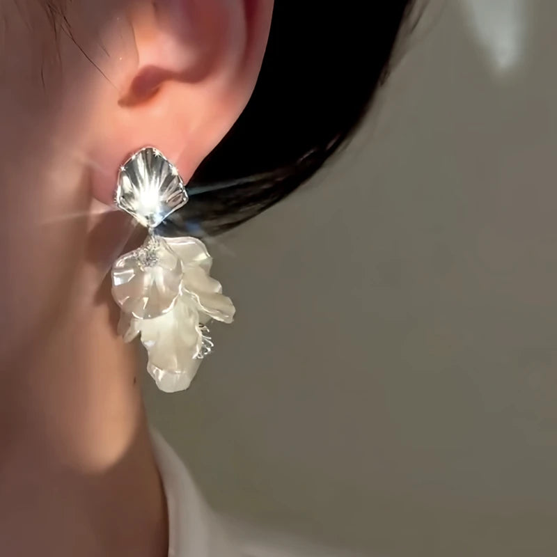Model showcasing the dangle and style of the 14K Gold-Plated Elegant Zircon White Petal Tassel Earrings