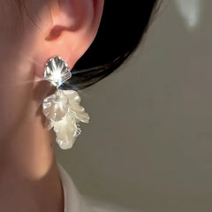 Model showcasing the dangle and style of the 14K Gold-Plated Elegant Zircon White Petal Tassel Earrings