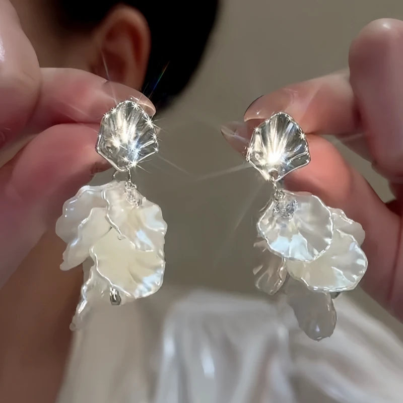 Angled view of the 14K Gold-Plated Elegant Zircon White Petal Tassel Earrings