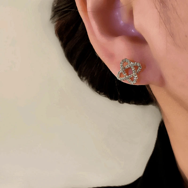 Model showcasing the dangle and style of the 14K Gold-Plated Elegant Zircon Winding Stud Earrings