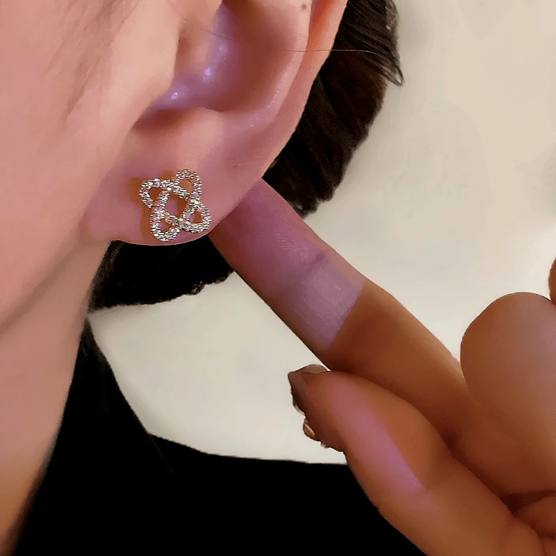 Close-up detail of the sparkling zircons and plating on the Winding Stud Earrings