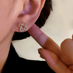 Close-up detail of the sparkling zircons and plating on the Winding Stud Earrings