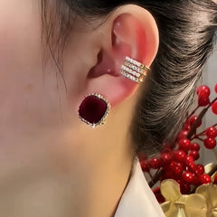 Model showcasing the dangle and style of the 14K Gold-Plated Elegant Zircon Wine Red Stud Earrings