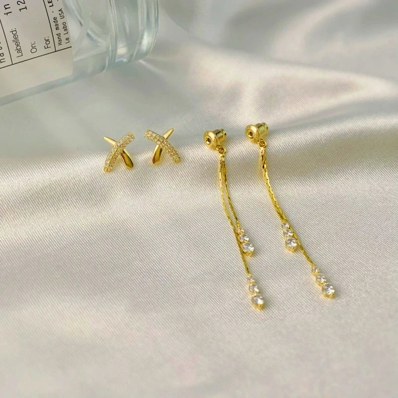 Angled view of the 14K Gold-Plated Elegant Zircon X Cross Tassel Earrings